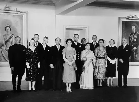 Queen Elizabeth and Prince Philip pose with diplomatic personnel at an embassy function during the 1957 Royal Visit