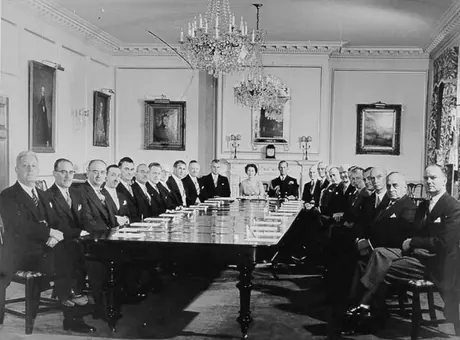 Queen Elizabeth, seated between Prince Philip and Prime Minister of Canada John Diefenbaker, poses with members of the Federal Cabinet