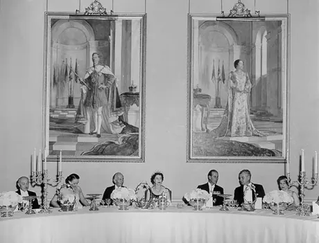 Queen Elizabeth, Prince Philip and Prime Minister of Canada John Diefenbaker attend an official state banquet during the 1957 Royal visit