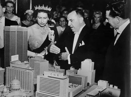 Queen Elizabeth examines a model of the new Queen Elizabeth Hotel and Canadian National Railways office complex during her 1959 Royal Tour