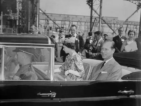 Queen Elizabeth and Prince Philip ride in an open limousine during the 1959 Royal Tour of Canada
