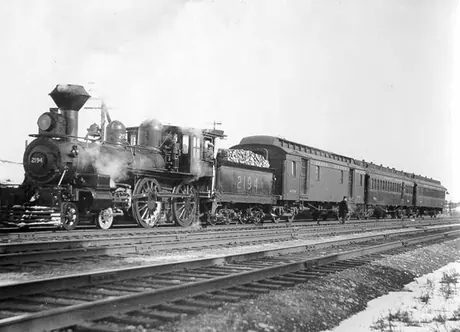 A Grand Trunk Railway passenger train hauled by wood burning steam locomotive no. 2194
