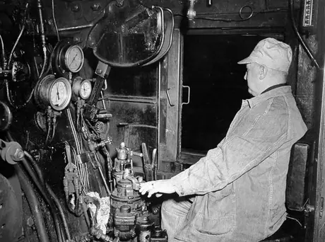 Locomotive engineer testing brakes on Canadian National Railways steam locomotive no. 6208