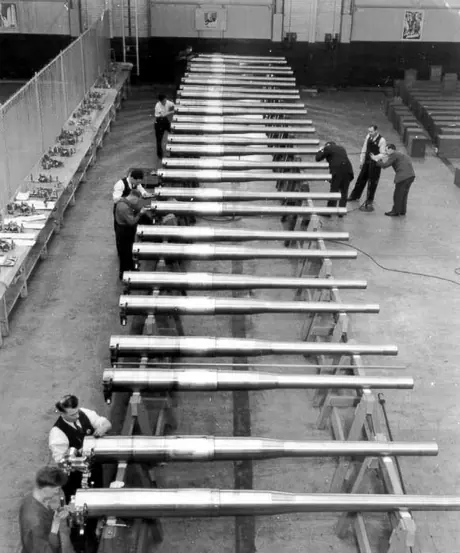Railwaymen conductiog final inspection on a line of finished guns at the CN munitions plant