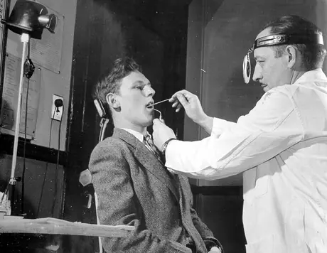 Doctor examining a patient's throat at the medical department clinic, Montreal