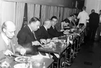 Directors and newspaper staff having lunch in the dining car