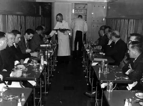 Directors and newspaper staff having lunch in the dining car