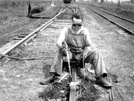 Member of the track gang working on the track