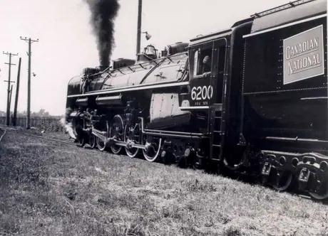 Side view of steam locomotive #6200, at MLW plant, ready to leave for delivery to CN