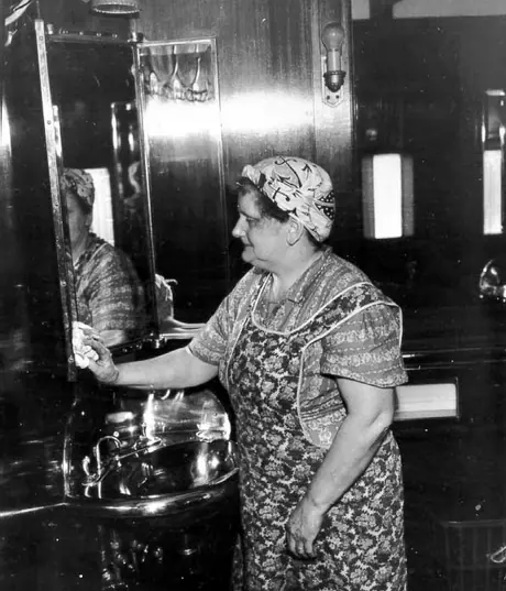CN empoyee cleaning the interior of a passenger car
