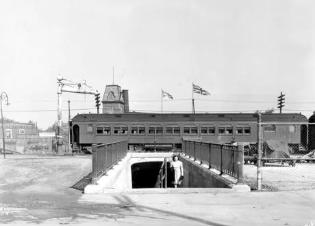 Passenger train traveling over a pedestrian underpass