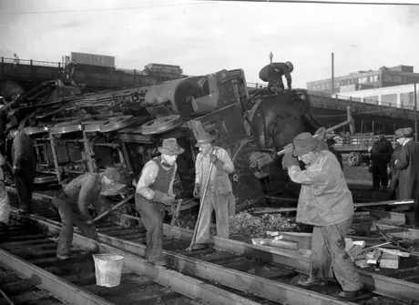 Steam locomotive 50 being replaced on track by CN employees after a collision, west of Bonaventure station
