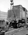 Steam locomotive 50 being replaced on track by CN employees after a collision, west of Bonaventure station