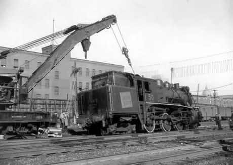 Steam locomotive 50 being replaced on track by CN employees after a collision, west of Bonaventure station