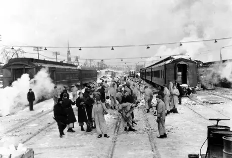 Soldiers clearing snow and ice off the tracks