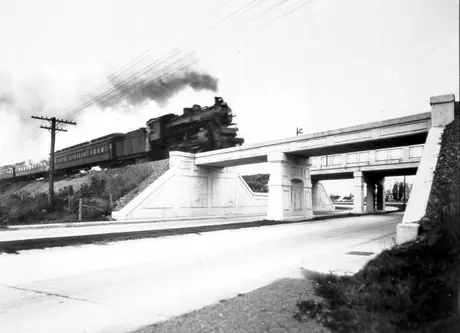 Passenger train traveling over Bout de l'Ile subway