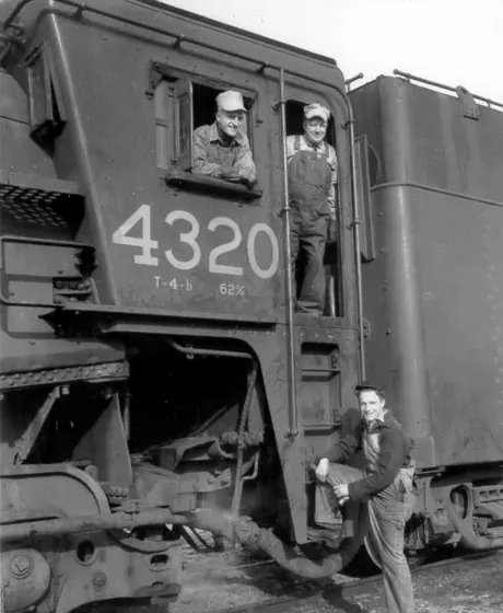 Three members of the Dixon family with locomotive cab 4320