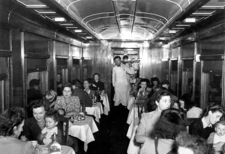 Repatriated women and children having a meal in the dining car
