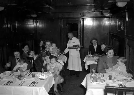 War brides and their children being served a meal enroute to their destinations