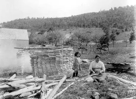 A Whycocomagh woman making baskets