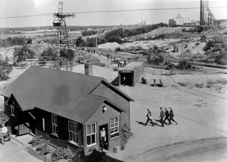 Miners, after changing their clothes, coming off their shift at the Hollinger Mine