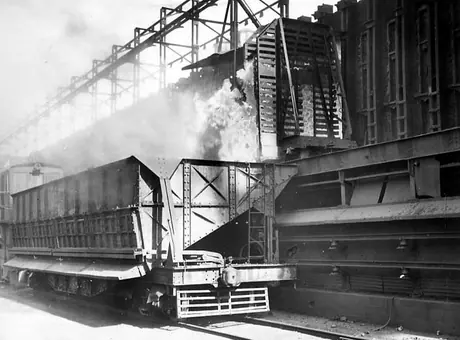 Massive coke ovens emptying their contents