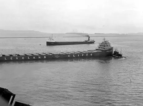 A Cleveland-Cliffs iron ore freighter leaving the docks