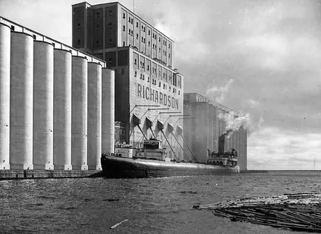 A cargo ship being loaded with grain at a Port Arthur elevator