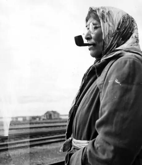 Cree woman smoking a pipe