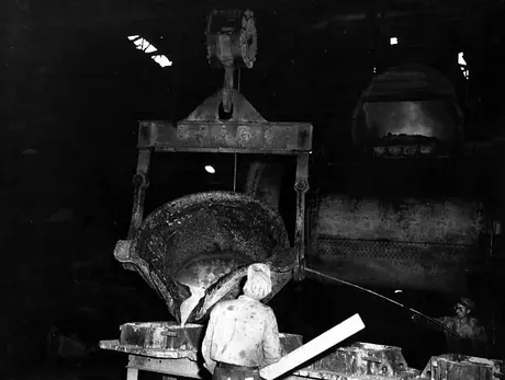Pouring moulten metal into moulds