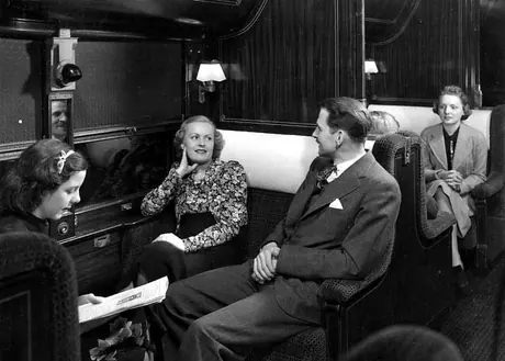 Passengers sitting in the standard air conditioned sleeping car