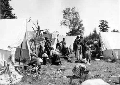 Ojibwa families living in prospector-type tents.
Original caption: