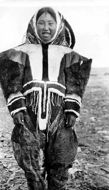 Front view of Inuk girl, Jennie Kanaicjuk, wearing decorative caribou skin clothing.
Original caption: