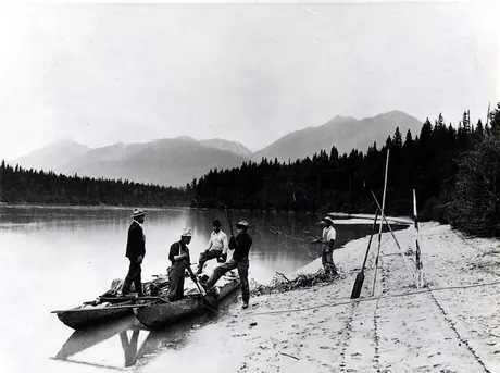 Five men beaching their double canoe.
Original caption: