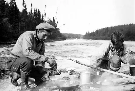 Two Ojibwa men preparing a shore lunch along the Ogoki River.
Original caption: