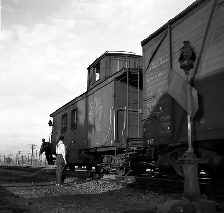 A Brakeman picks up train orders on the move at Turcot West, for westbound train 495 en route to Brockville.
