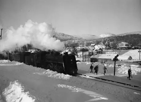 Passenger train pulling into the station at a ski resort