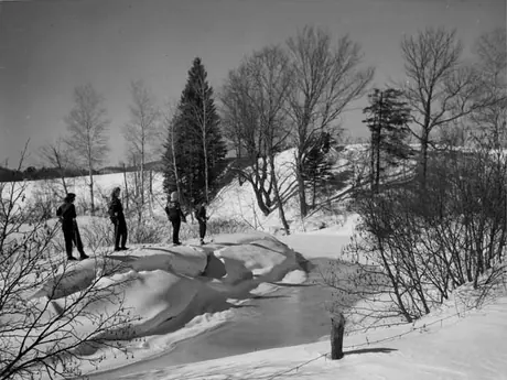 Cross-country skiing by a riverbank at Saint-Sauveur-des-Monts