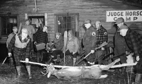 A hunting party examining its kill