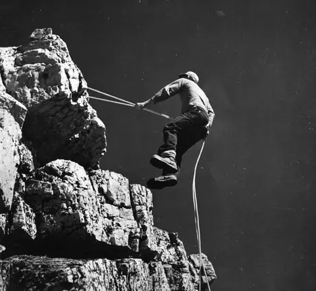 A mountain climber scaling the rocks
