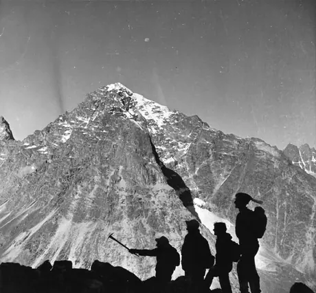 Silhouettes of mountain climbers against the background of the mountains
