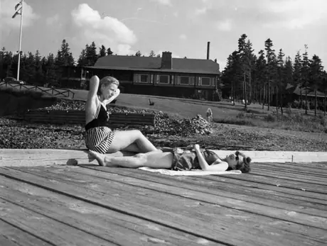 Two women sunbathing on the pier, Pictou Lodge