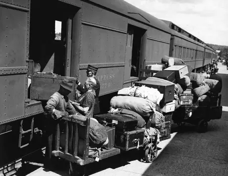 Railroad workers handling baggage at Huntsville station