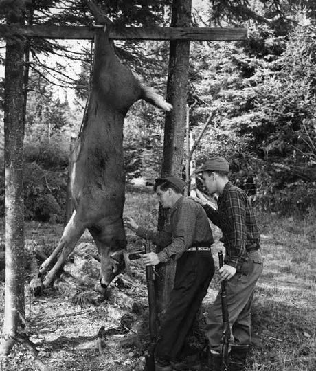 Hunters examining their game, Saint-Adolphe