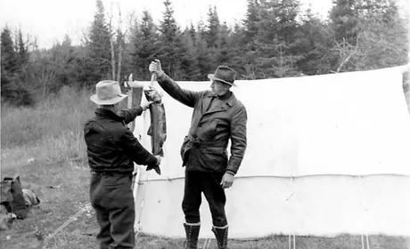 Fisherman with grey trout, Burnt Lake