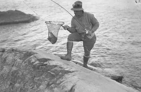 Fisherman examining his catch, Pickerel River Resort