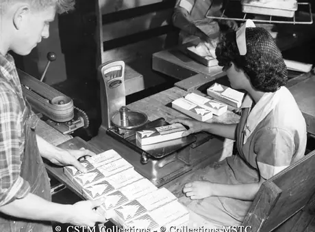 Weighing packages of flounder filets at the Job Brothers and Co, Ltd. Fish Plant