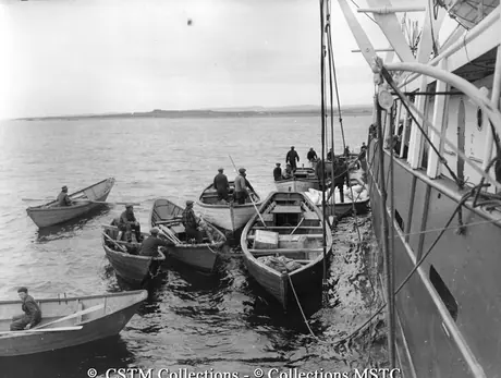 Freight being loaded from steamer as lack of depth of water in the harbour prevents it from tying up at a wharf