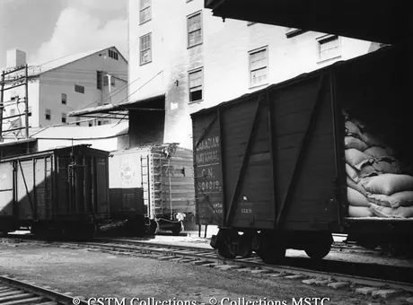 Freight cars at loading platforms of mine, Asbestos, Que