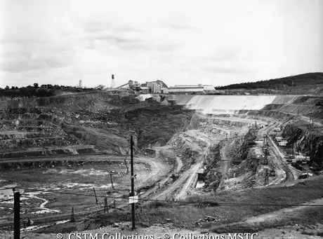 View of open pit mine looking toward crushing and extracting plant